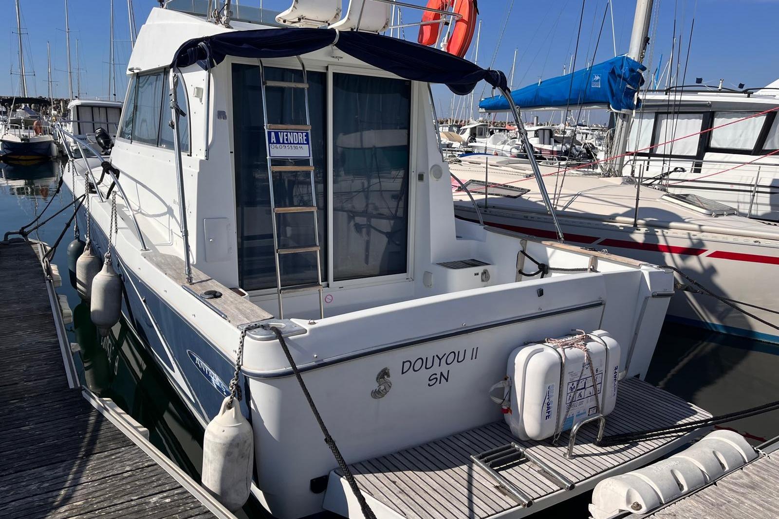 Beneteau Antares 9 Fly 2006 Beneteau Antares 9 Fly boat docked, for sale sign visible, marina background.