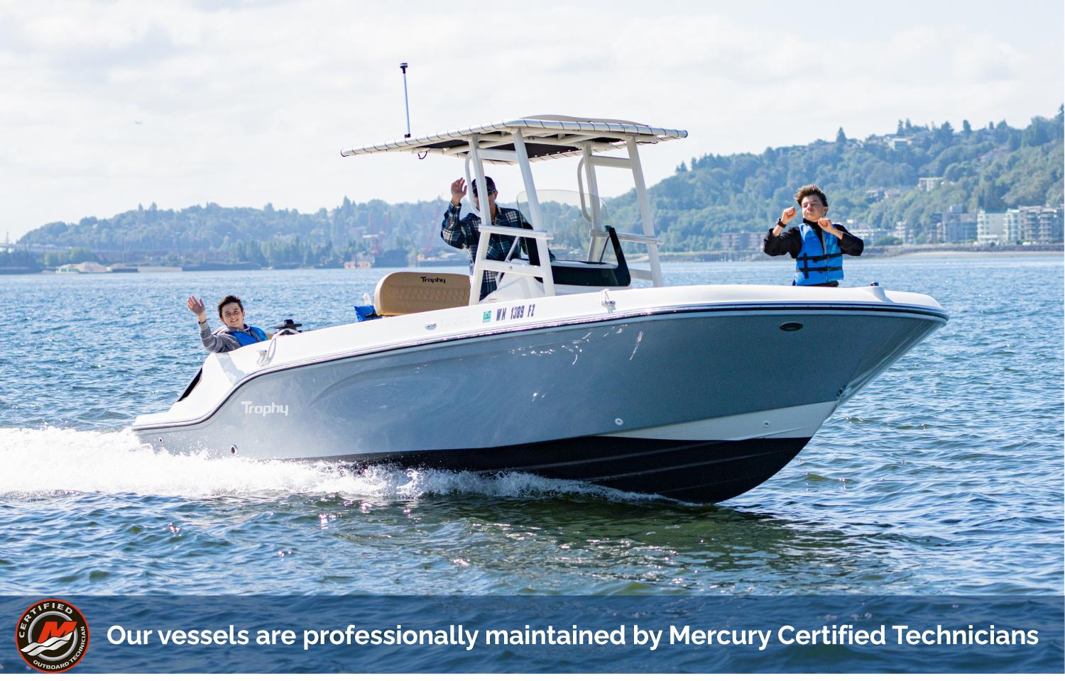 Bayliner Trophy 2021 Bayliner Trophy boat cruising on water, passengers waving, with scenic background.
