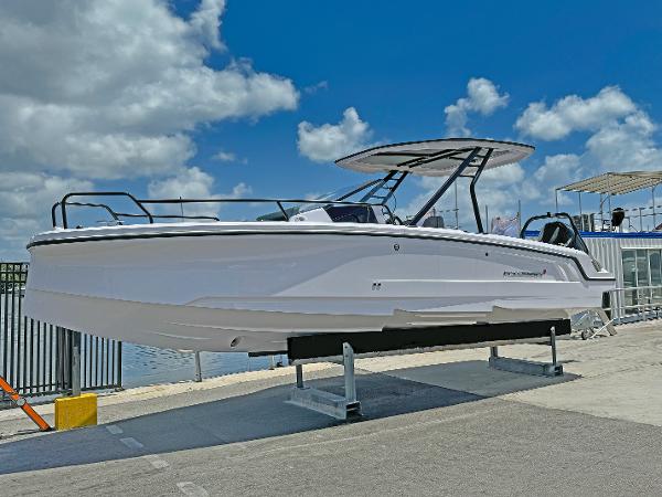 Axopar 25 Cross Top 2025 Axopar 25 Cross Top boat displayed on a stand under a blue sky.