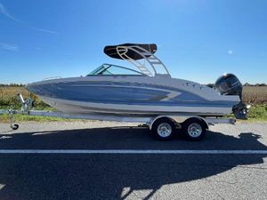 Chaparral 23 SSi OB 2024 Chaparral 23 SSi OB boat on a trailer under a clear blue sky.