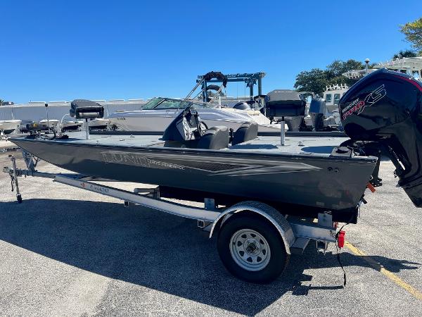 Lund Renegade 2020 Lund 1875 Predator fishing boat on a trailer in a parking lot.
