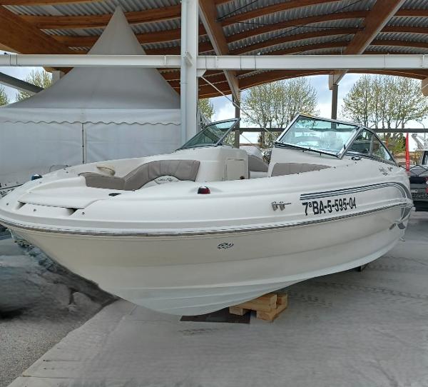 Sea Ray 200 Sundeck 2004 Sea Ray 200 Sundeck boat displayed indoors, featuring sleek design and comfortable seating.