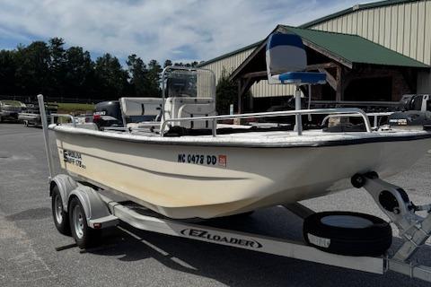 Carolina Skiff 178 DLX 2006 Carolina Skiff 178 DLX boat on EZ Loader trailer, parked outdoors.