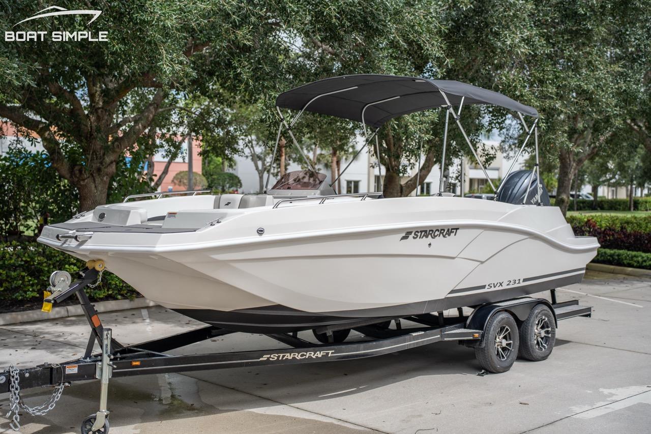 Starcraft SVX 231 OB DH 2023 Starcraft SVX 231 OB DH boat on trailer, parked outdoors.
