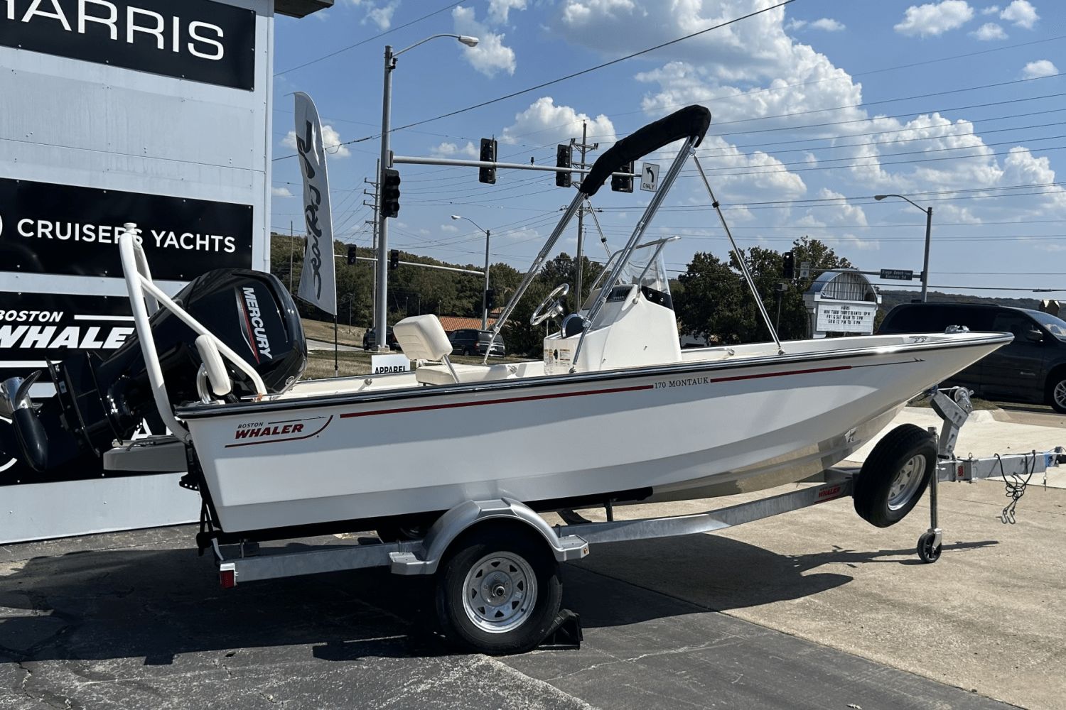 Boston Whaler 170 Montauk 2025 Boston Whaler 170 Montauk boat on trailer, displayed outdoors under a sunny sky.