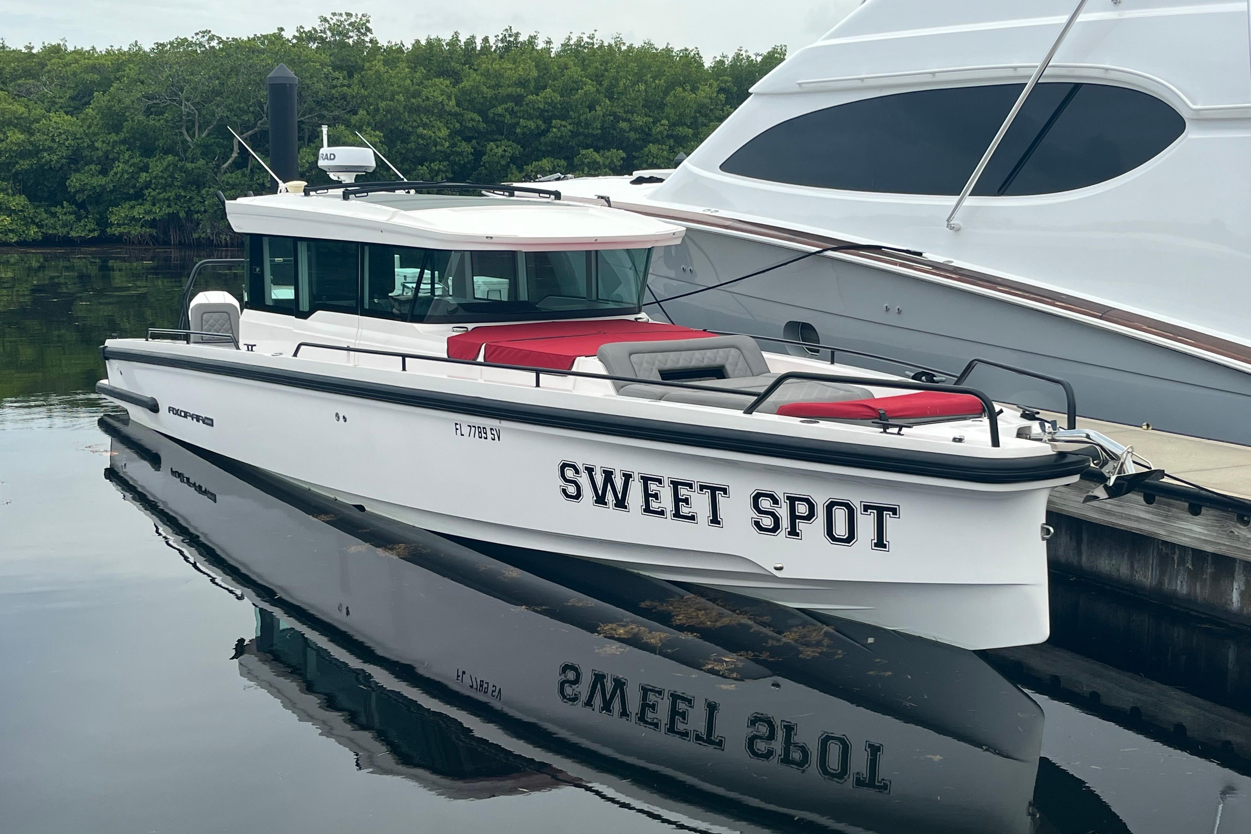 Axopar 37 Cross Cabin 2021 Axopar 37 Cross Cabin boat named "Sweet Spot" docked by the water.