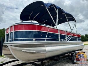 South Bay 224CR LE 2025 South Bay 224CR LE pontoon boat with blue and red exterior on a trailer.