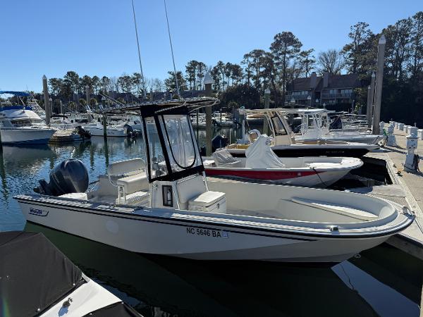 Boston Whaler Outrage 1983 Boston Whaler OUTRAGE boat docked at marina, surrounded by other vessels.