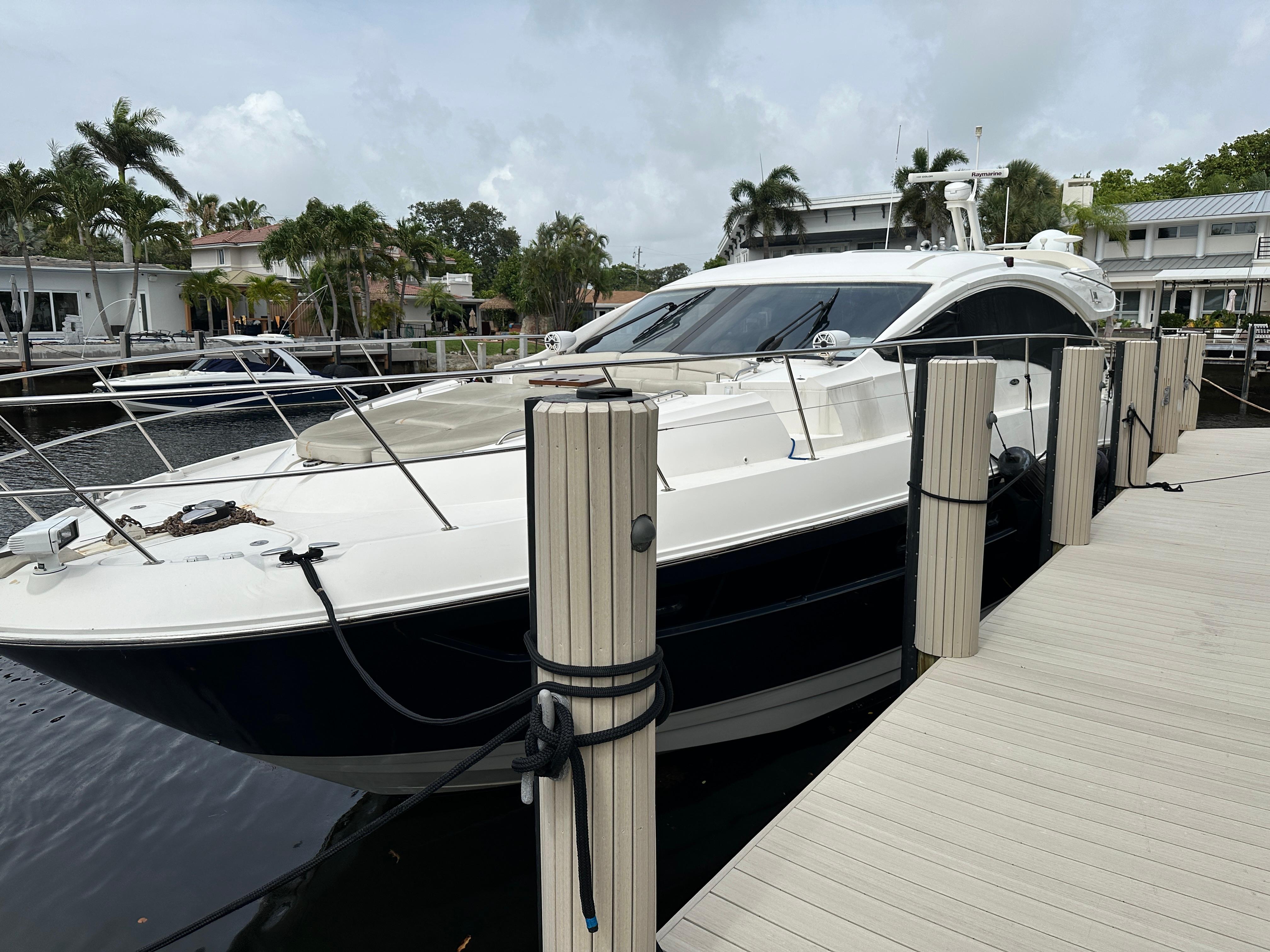 Sea Ray L590 2016 Sea Ray L590 yacht docked at marina with palm trees in background.