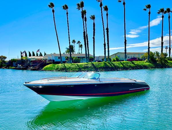 Chris-Craft Corsair 28 2005 Chris-Craft Corsair 28 boat on a sunny day, surrounded by palm trees.