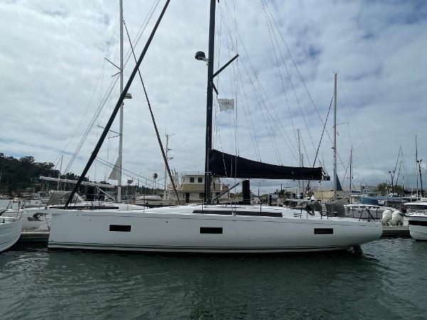 Beneteau First 44 2024 Beneteau First 44 sailboat docked at a marina under cloudy skies.
