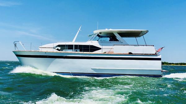 Chris-Craft 46 Roamer 1969 Chris-Craft 46 Roamer yacht cruising on open water under a clear blue sky.