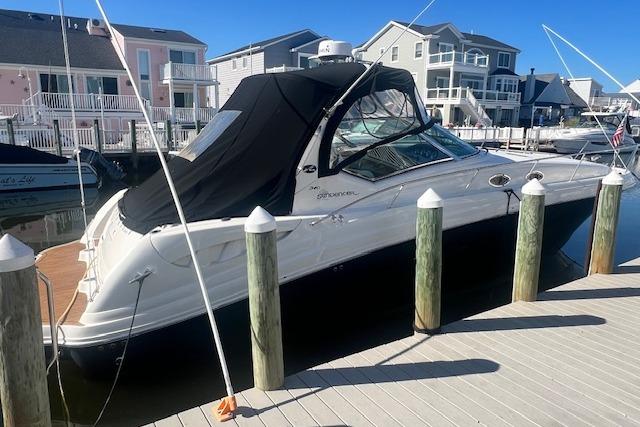 Sea Ray 340 Sundancer 2008 Sea Ray 340 Sundancer docked at a marina with waterfront homes in the background.