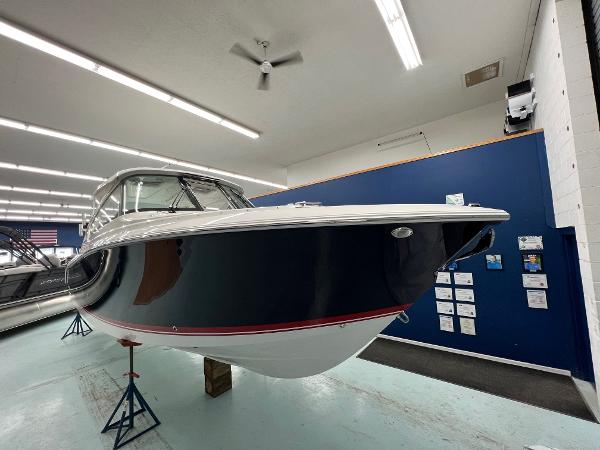 Pursuit DC 306 Dual Console 2025 Pursuit DC 306 Dual Console boat displayed indoors, showcasing sleek design and modern features.