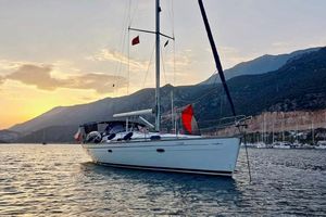 Bavaria Cruiser 46 Bavaria 46 Cruiser 2007 yacht at sunset, anchored near mountainous coastline.