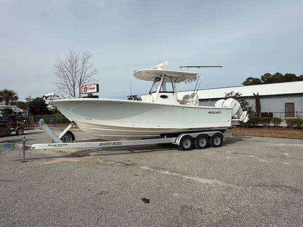 Regulator 28 2022 Regulator 28 boat on trailer in parking lot, side view.