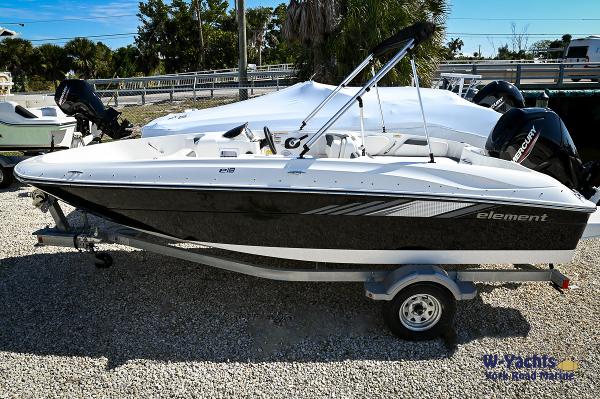 Bayliner E18 2023 Bayliner E18 boat on a trailer in a sunny outdoor setting.