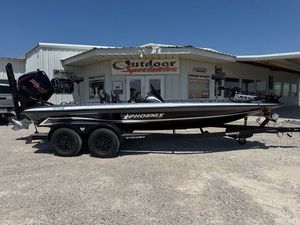 Phoenix 920 Elite X 2026 Phoenix 920 Elite X boat parked outside a dealership under clear blue skies.
