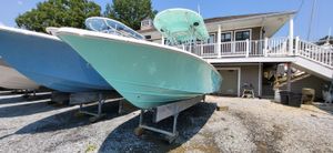 Sea Chaser 23 LX 2023 Sea Chaser 23 LX boat in a marina, displayed on stands.