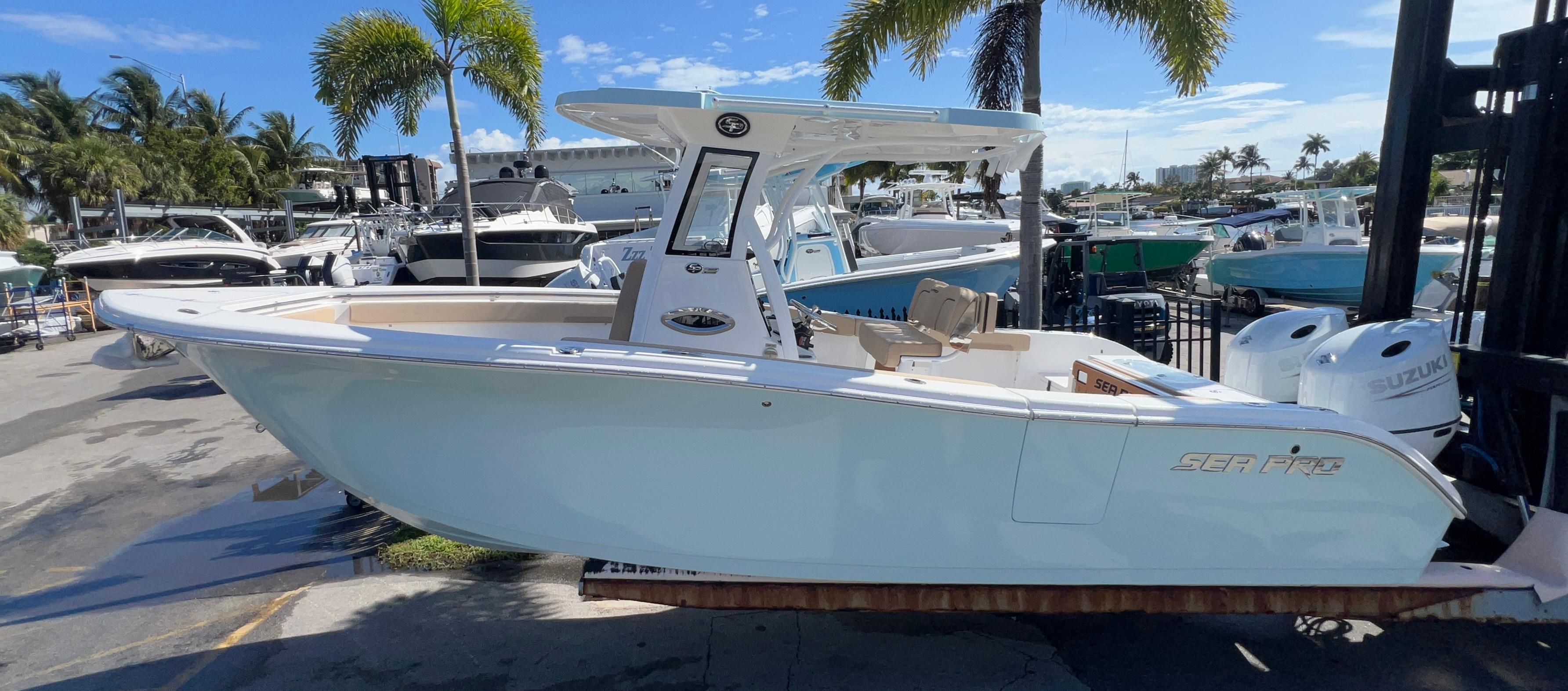 Sea Pro 262 Sport 2026 Sea Pro 262 Sport boat displayed at a marina with palm trees and other boats.