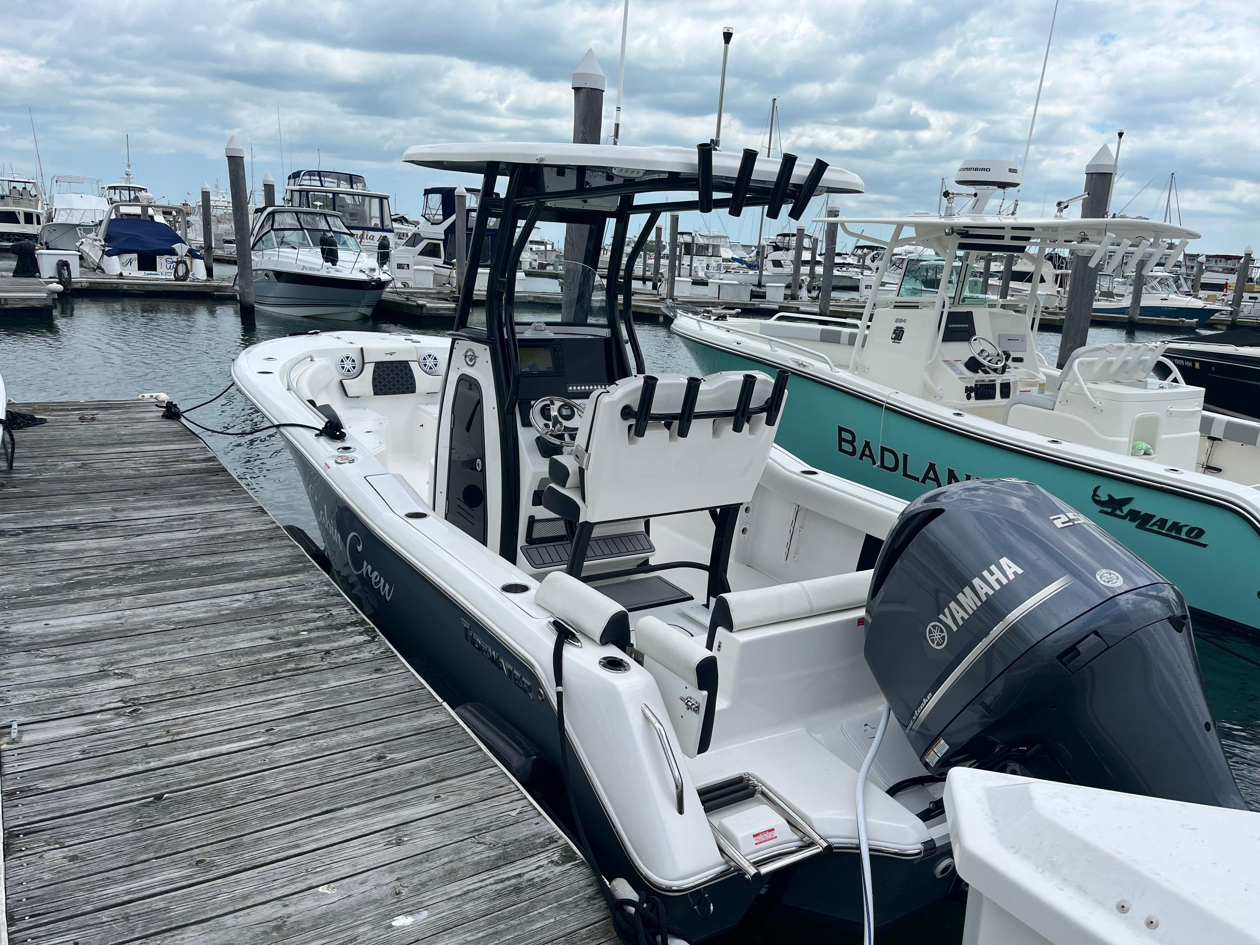Tidewater 232 LXF 2021 Tidewater 232 LXF boat docked with Yamaha engine, cloudy sky background.