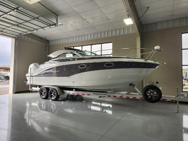 Crownline 280 CRX 2024 Crownline 280 CRX boat on a trailer in a showroom.