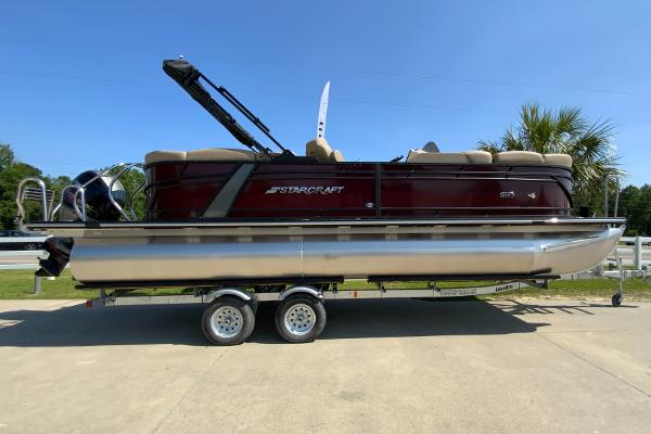 Starcraft SLS 3 2024 Starcraft SLS 3 pontoon boat on a trailer under a clear blue sky.