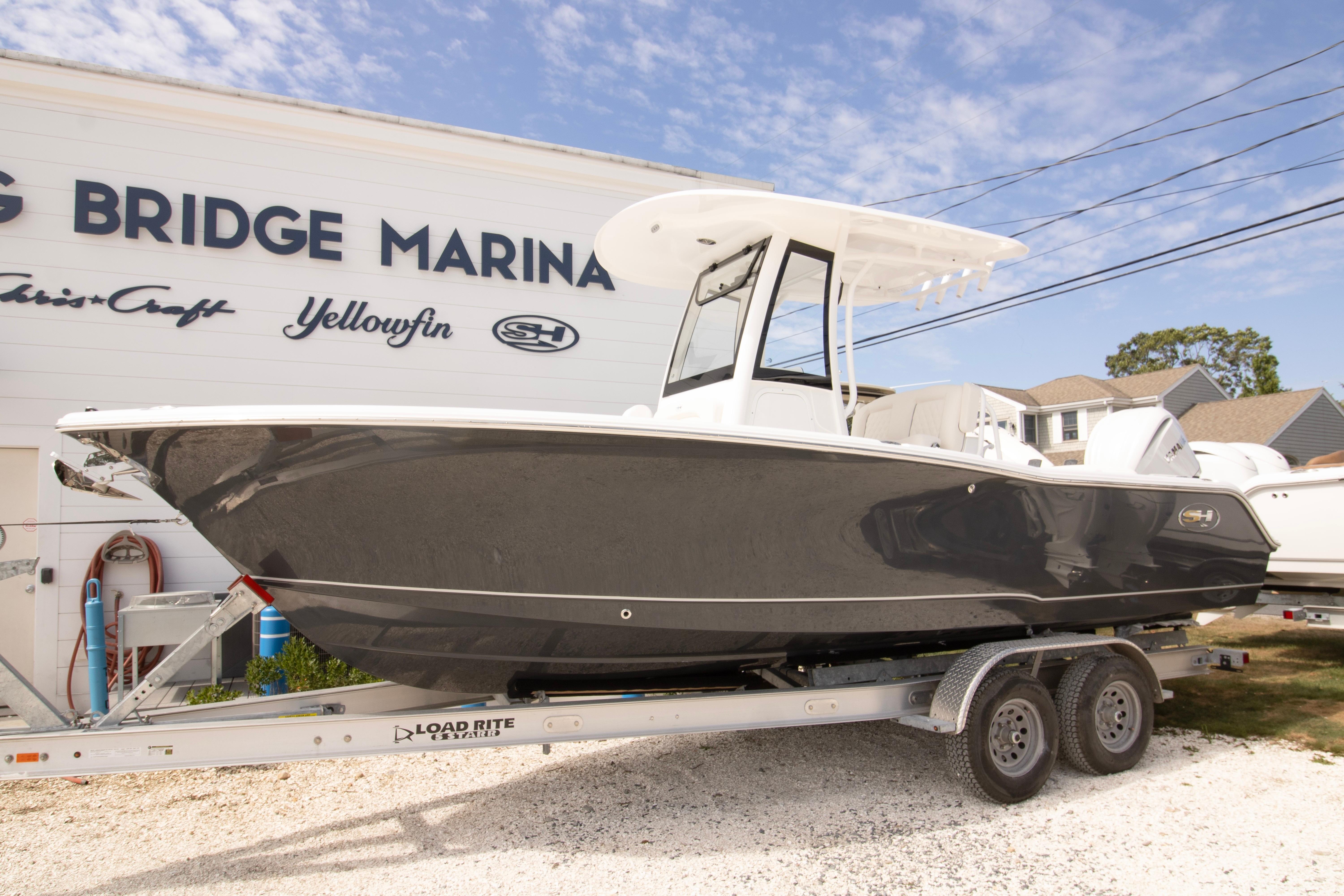 Sea Hunt Ultra 245 SE 2026 Sea Hunt Ultra 245 SE boat on trailer at marina.