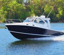 Pursuit OS 325 Offshore 2023 Pursuit OS 325 Offshore boat cruising on a scenic lake.