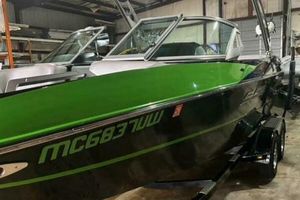 MB B52 21Classic 2017 MB B52 21 Classic boat with green and black exterior in a storage facility.