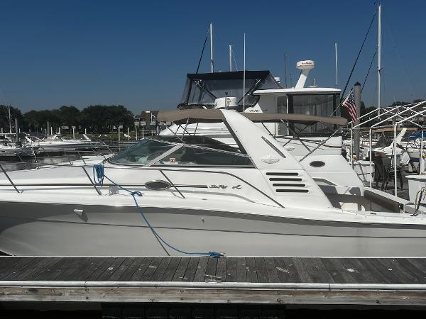 Sea Ray 330 Express Cruiser 1997 Sea Ray 330 Express Cruiser docked at marina under clear blue sky.