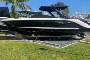 Sea Ray 310 SLX 2017 Sea Ray 310 SLX boat on display, surrounded by palm trees and other boats.