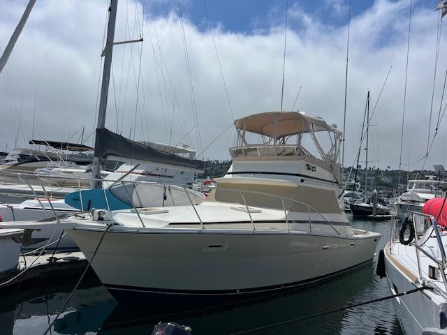 Viking Boats 35 Convertible 1981 Viking Boats 35 Convertible yacht docked in marina under cloudy sky.