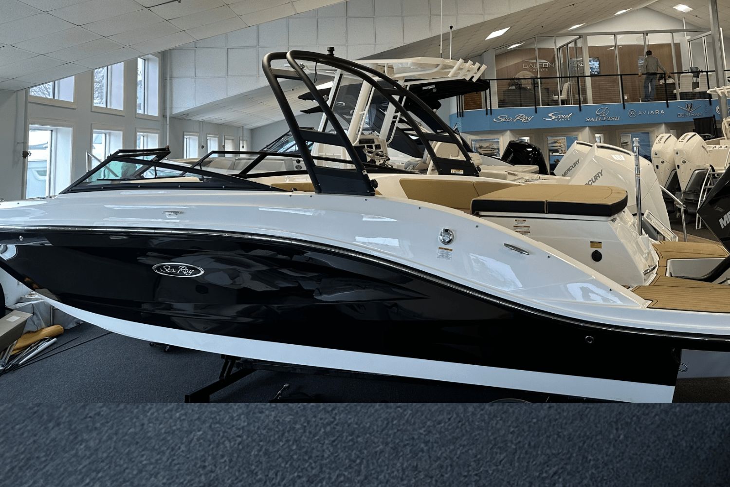 Sea Ray SPX 230 Outboard 2025 Sea Ray SPX 230 Outboard boat displayed in a showroom.