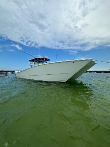 Freeman 42LR 2021 Freeman 42LR boat on calm green water under a partly cloudy sky.