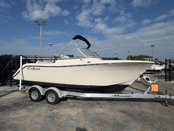 Cobia 220 Dual Console 2020 Cobia 220 Dual Console boat on trailer, parked outdoors under a partly cloudy sky.
