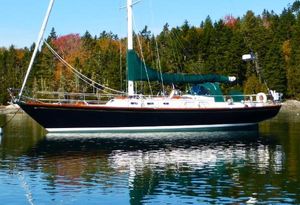 Hinckley Sou'wester 51 1986 Hinckley Sou'wester 51 sailboat on calm water, surrounded by autumn trees.