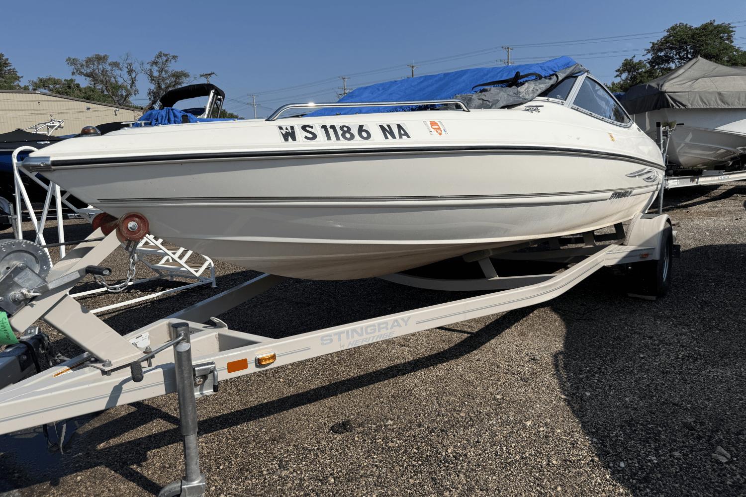 Stingray 185 LX 2010 Stingray 185 LX boat on trailer, parked outdoors.