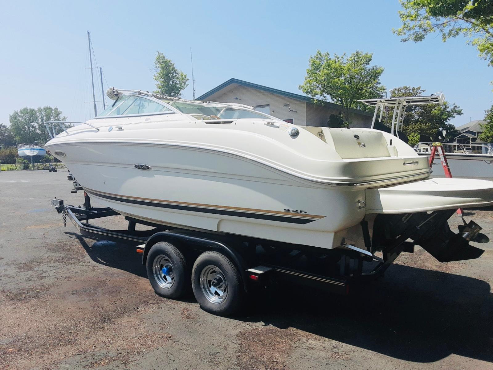 Sea Ray 225 Weekender 2001 Sea Ray 225 Weekender boat on trailer, parked outdoors.