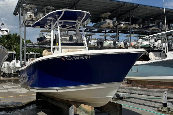 NauticStar 2102 Legacy 2018 NauticStar 2102 Legacy boat in storage, blue hull, marina background.