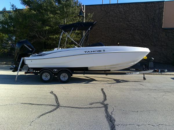 Tahoe T21 2024 Tahoe T21 boat on trailer in parking lot.
