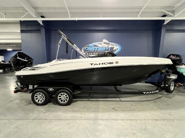 Tahoe T21 2025 Tahoe T21 boat on trailer in showroom, side view.
