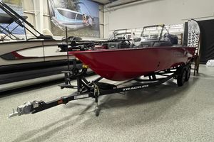 Tracker Targa V-19 Combo 2026 Tracker Targa V-19 Combo boat in showroom, red hull, on trailer.