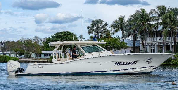 Scout 420 LXF 2019 Scout 420 LXF boat named "Hellkat" cruising on a scenic waterway.