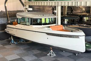 Saxdor 320 GTC 2022 Saxdor 320 GTC boat displayed indoors with orange seating and sleek design.