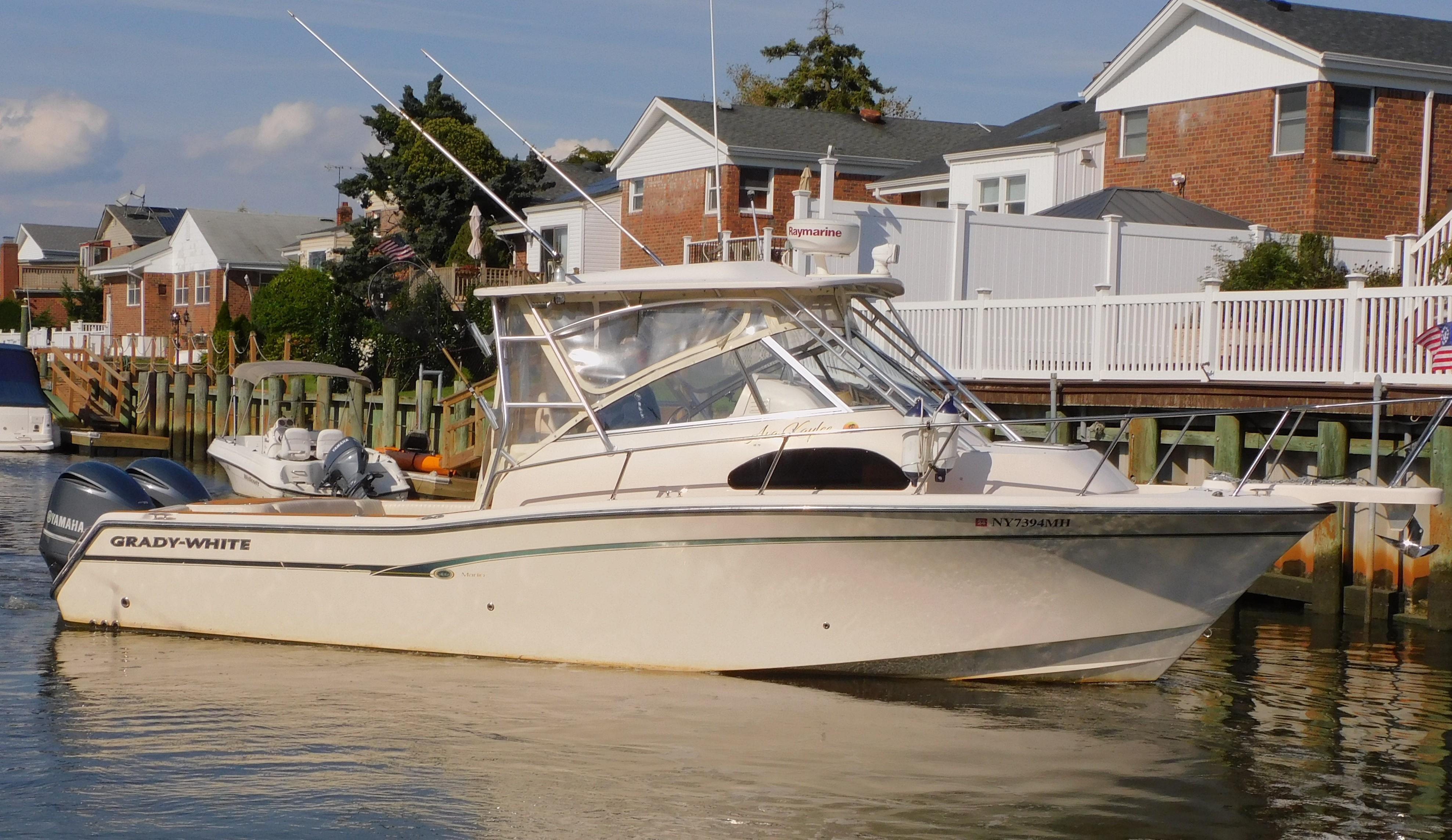 Grady-White Marlin 300 2012 Grady-White Marlin 300 boat docked near waterfront homes.