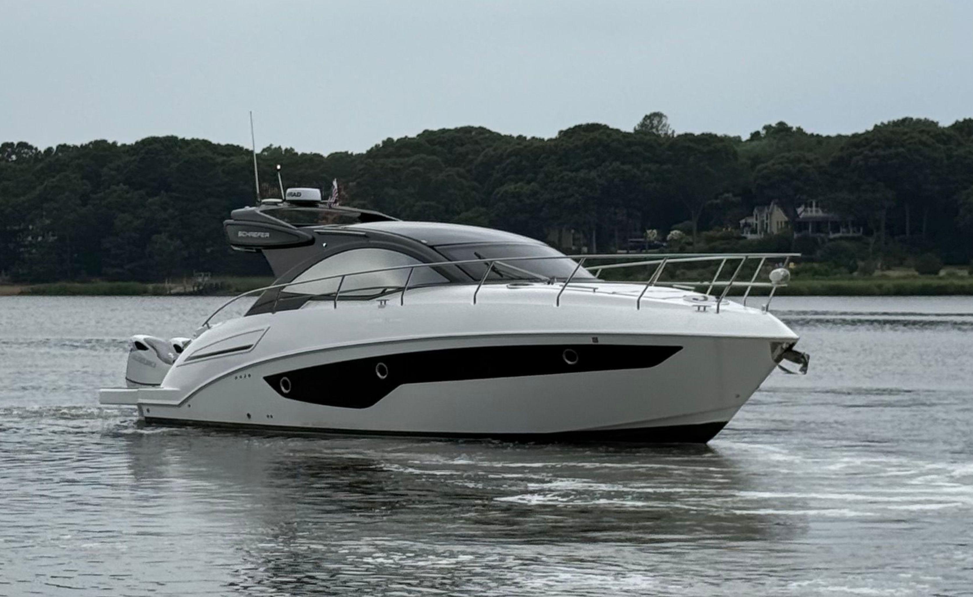Schaefer 400 Sport 2022 Schaefer 400 Sport yacht cruising on a calm lake with forested shoreline.