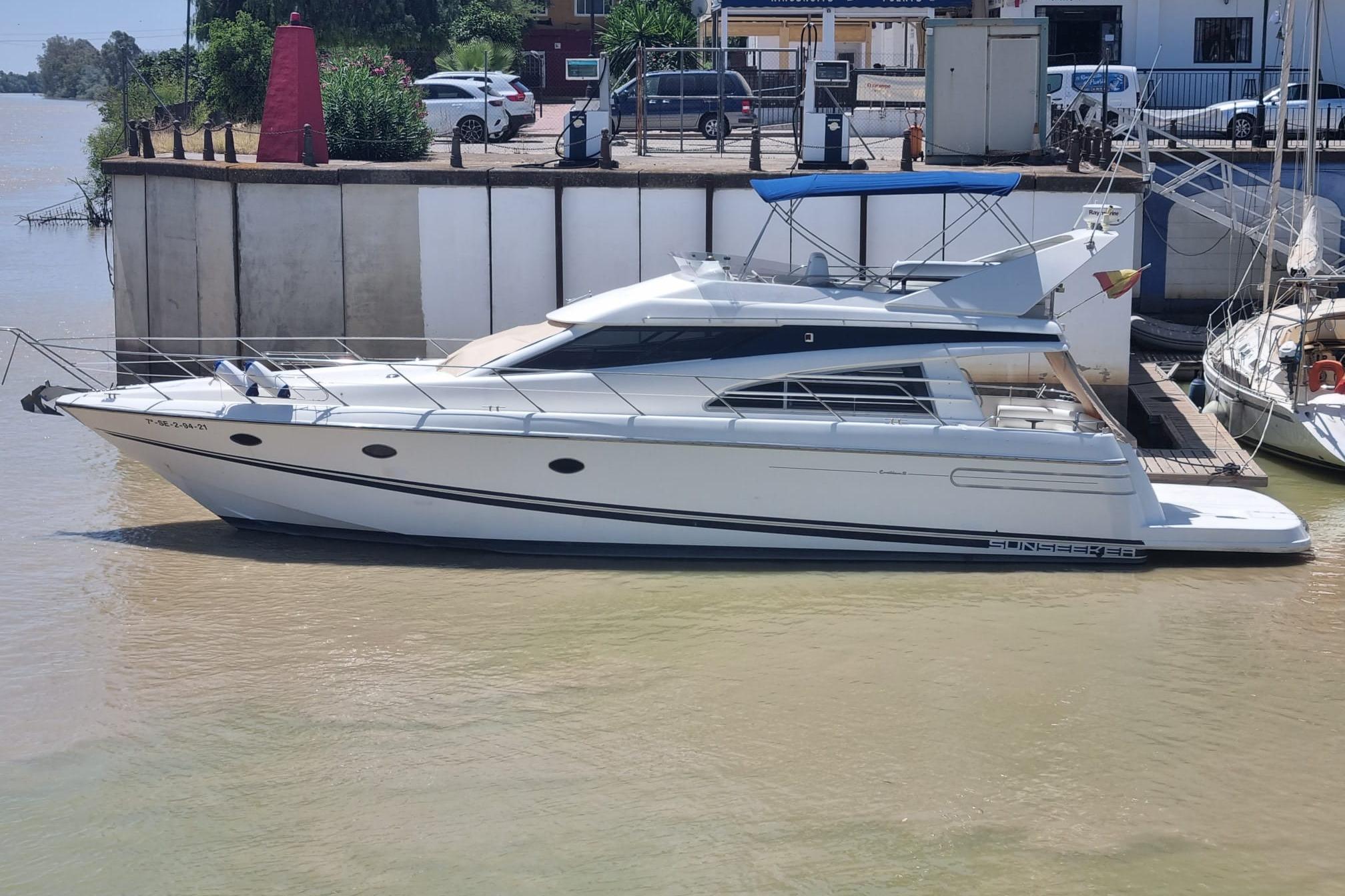 Sunseeker Caribbean 52 1992 Sunseeker Caribbean 52 yacht docked at a marina, side view.