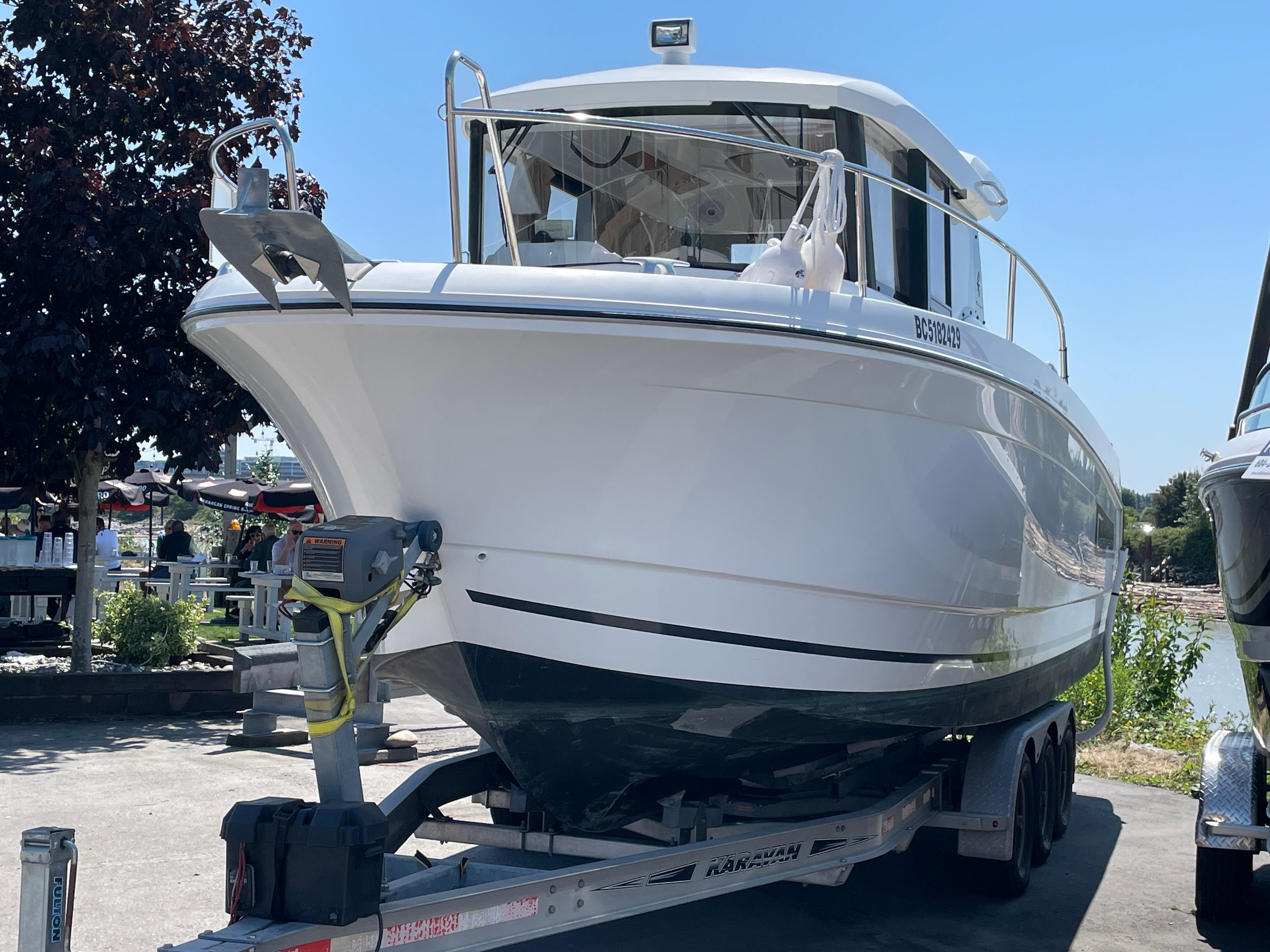 Jeanneau Merry Fisher 855 Marlin 2016 Jeanneau Merry Fisher 855 Marlin boat on trailer, parked outdoors.