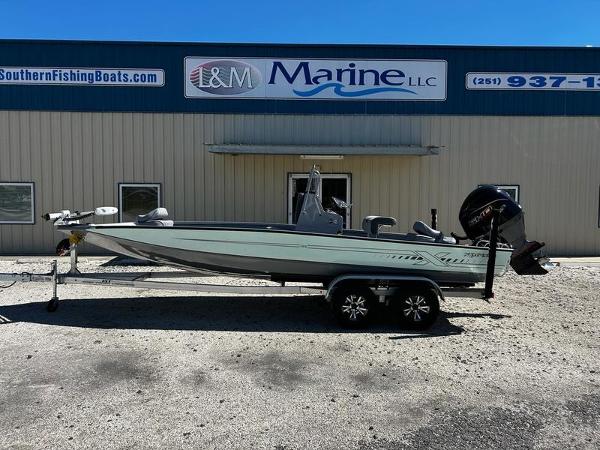 Xpress H22B 2025 Xpress H22B boat on trailer outside marine dealership.